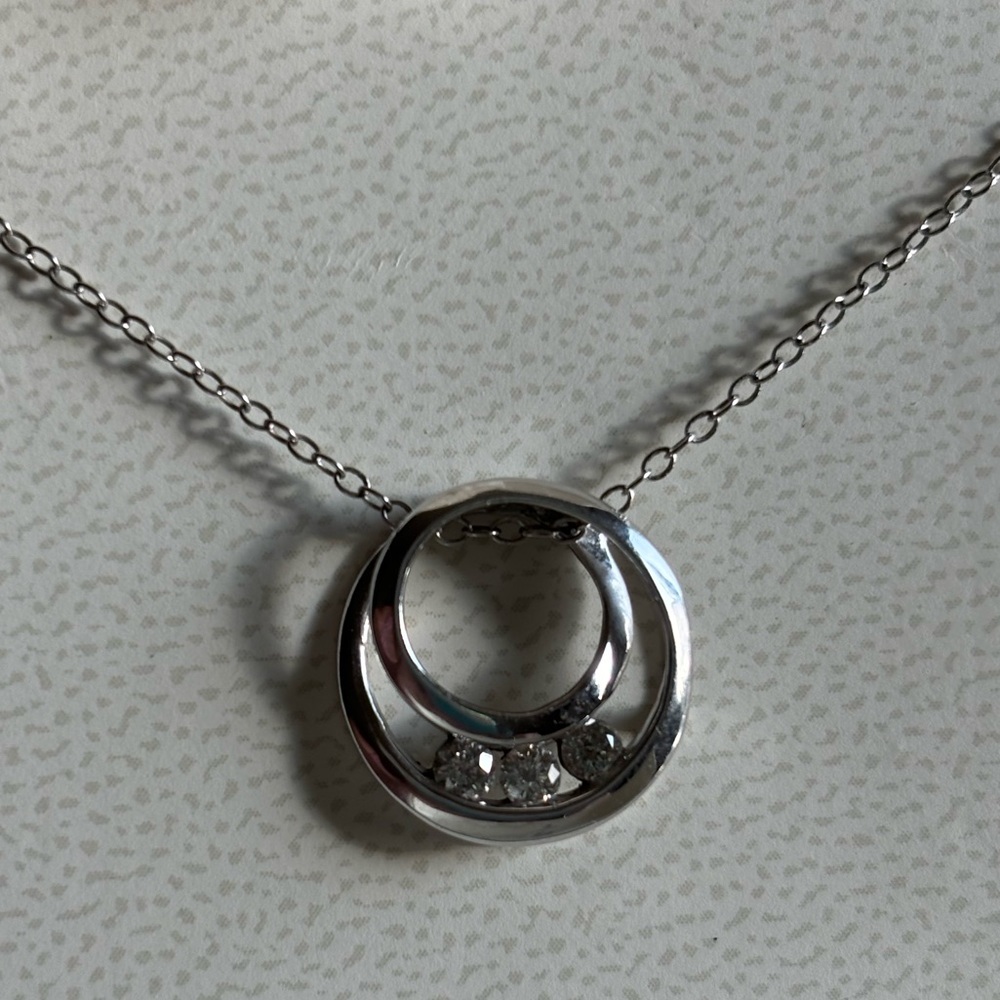 10KT stamped circular swirl pendant with 3 Rd diamonds